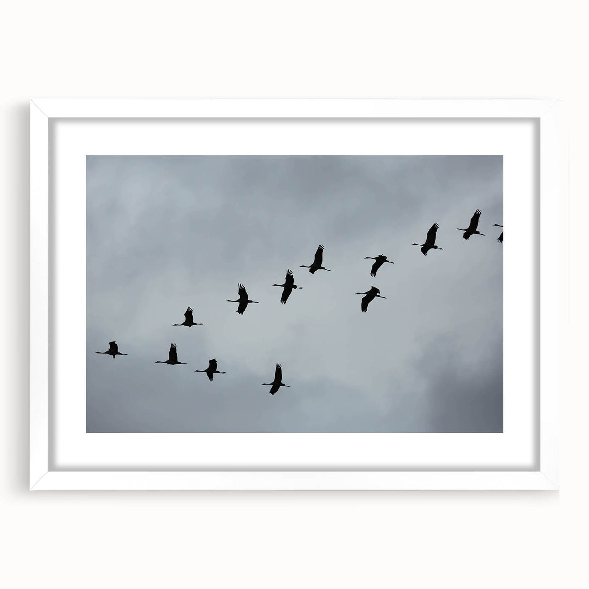Framed wall art featuring a graceful crane design in a minimalist style, showcased with a white mat and sleek black frame, ideal for modern decor.