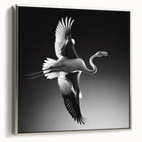 Framed canvas wall art featuring a vibrant flamingo design, accented with a sleek silver frame, ideal for modern home decor. Perfect for adding a tropical touch to any room.