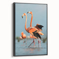Framed canvas wall art featuring a vibrant flamingo design, showcased in a sleek black frame, perfect for adding a touch of elegance to any room's decor.