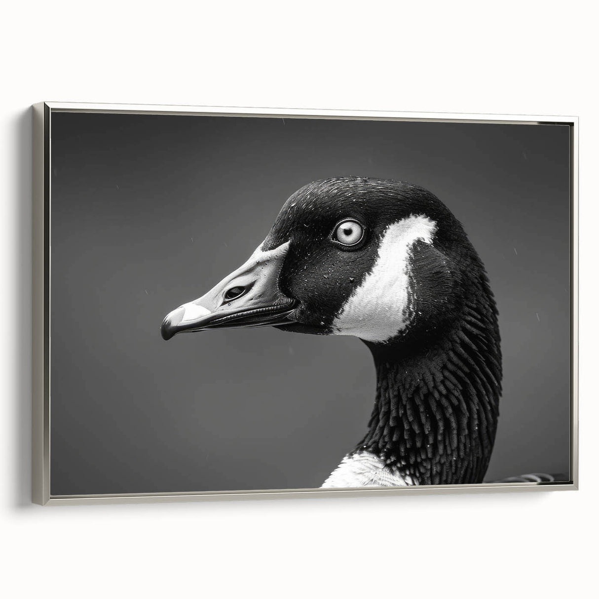 Framed wall art featuring a serene goose design on canvas, displayed from a side view with a sleek silver frame, perfect for enhancing modern home decor.