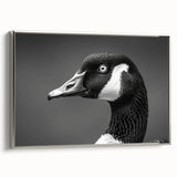 Framed wall art featuring a serene goose design on canvas, displayed from a side view with a sleek silver frame, perfect for enhancing modern home decor.