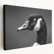 Stretched canvas wall art featuring a serene design of geese in flight against a soft blue background, perfect for enhancing home decor with nature-inspired elegance.
