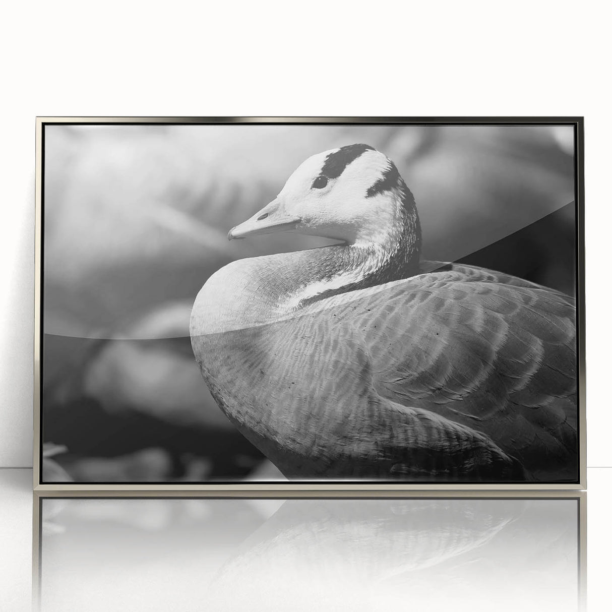 Framed wall art collection showcasing a stylish goose design in silver acrylic, set against a sleek background, perfect for modern home decor.