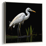 Framed wall art showcasing a serene heron and egret design on canvas, featuring a silver frame that enhances the elegant look, perfect for home decor.