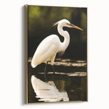 Framed wall art featuring a side view of a heron and egret in a golden color palette, showcasing elegant bird designs that enhance home decor aesthetics.