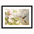 Framed wall art featuring a vibrant hummingbird design in a black frame with a mat, perfect for adding a colorful touch to home décor. Ideal for bird lovers and nature enthusiasts.