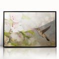 Framed wall art showcasing a vibrant hummingbird design in black acrylic, set against a sleek black frame, perfect for adding color and elegance to any room decor.