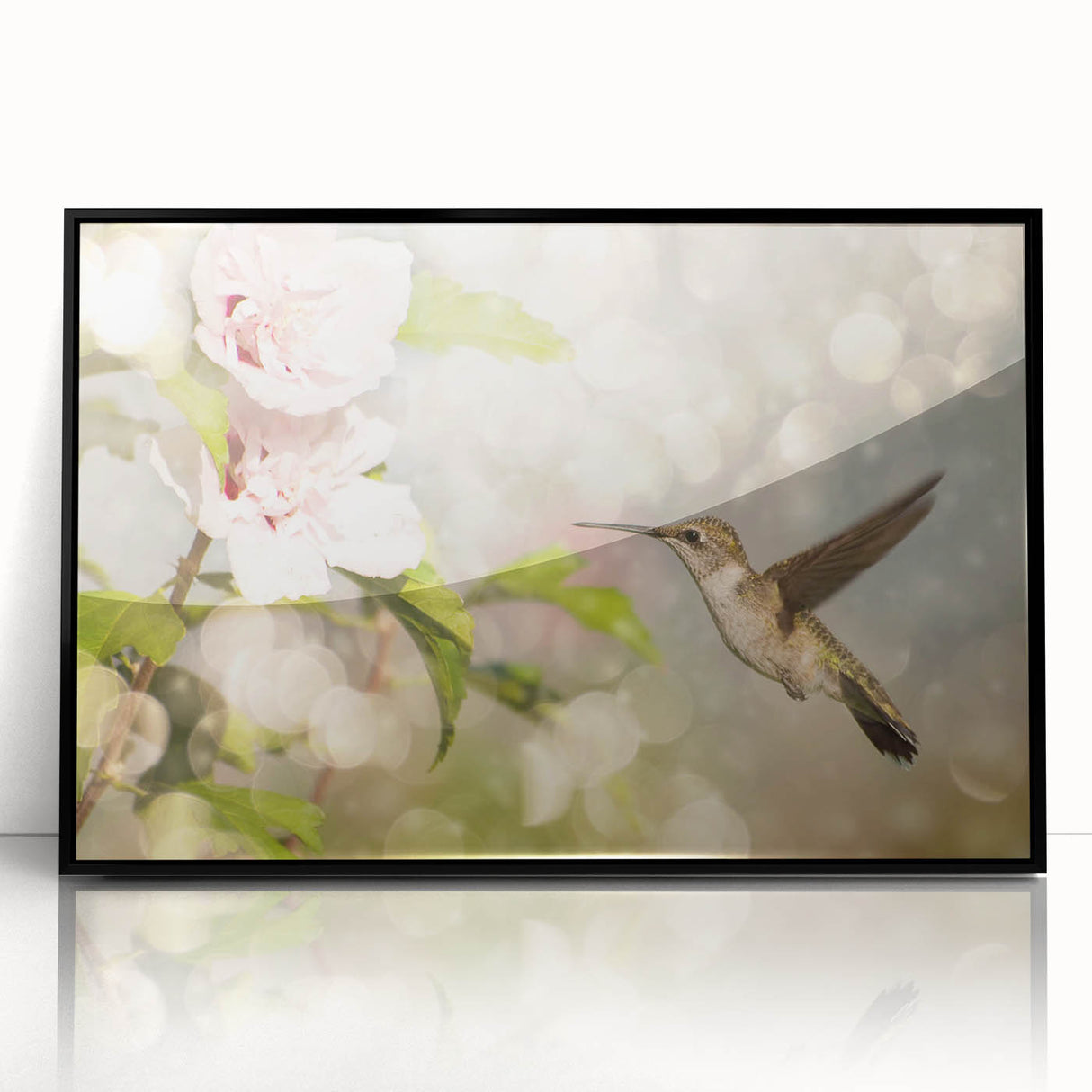Framed wall art showcasing a vibrant hummingbird design in black acrylic, set against a sleek black frame, perfect for adding color and elegance to any room decor.