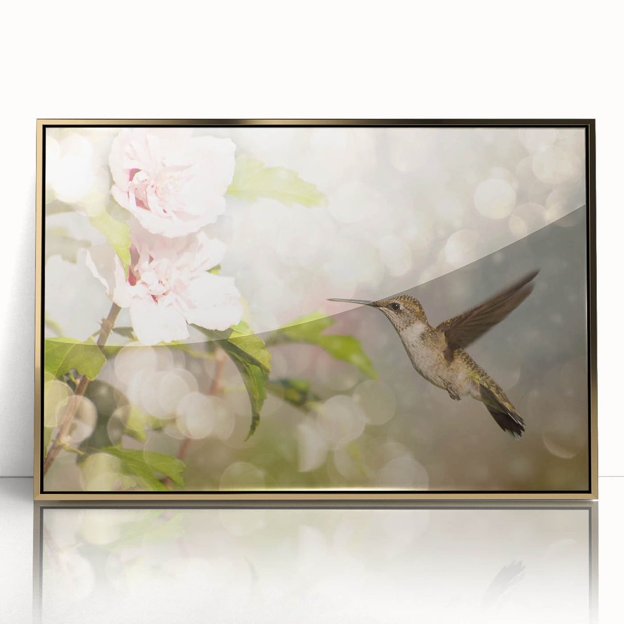 Framed wall art design showcasing a vibrant hummingbird in flight, set against an elegant gold background, perfect for adding a touch of nature-inspired decor to any room.