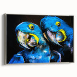 Framed canvas wall art showcasing a vibrant collection of colorful parrots, elegantly displayed against a silver frame, perfect for adding a tropical touch to home decor. The artwork features intricate details and lively colors, emphasizing the beauty of these exotic birds.