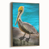 Framed canvas wall art featuring a side view of a golden pelican design, perfect for coastal decor, highlighting intricate details and vibrant colors.