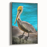 Framed wall art showcasing a silver pelican design on textured canvas, viewed from the side, perfect for elegant home decor or coastal-themed interiors.
