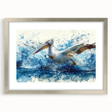 Silver-framed wall art featuring a vibrant pelican design, elegantly matted, ideal for coastal-themed decor. Perfect for enhancing living spaces with nature-inspired aesthetics.