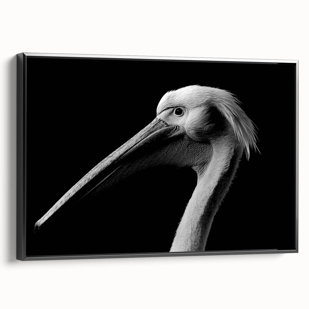 Framed canvas wall art featuring a side view of a stylized pelican design in black, perfect for enhancing modern home decor with a touch of elegance.