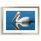 Silver-framed wall art featuring a serene pelican design, beautifully matted, ideal for coastal decor. Perfect for enhancing living spaces with a touch of elegance.
