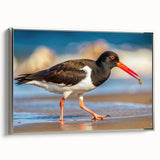 Framed canvas wall art collection showcasing a serene shorebird design in soft colors, displayed in a silver frame, adding elegance to any coastal-themed decor.