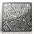 Framed black and white abstract wall art featuring dynamic geometric shapes and lines, showcasing a modern aesthetic for contemporary decor.