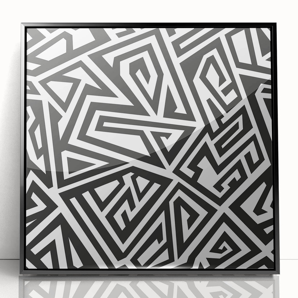Framed black and white abstract wall art featuring dynamic geometric shapes and lines, showcasing a modern aesthetic for contemporary decor.