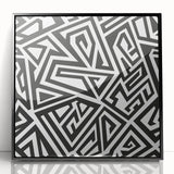 Framed black and white abstract wall art featuring dynamic geometric shapes and lines, showcasing a modern aesthetic for contemporary decor.