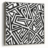 Framed black and white abstract wall art featuring a modern design with fluid shapes and textures, set against a silver frame.