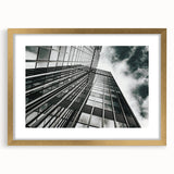 Textured abstract art print in black and white, framed in gold, suitable for modern bedroom decor.