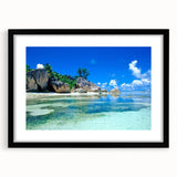 Extra large colorful abstract art print of a Seychelles scenery on textured canvas, framed in black.