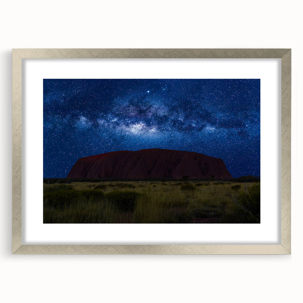 Abstract art print of Ayers Rock in muted orange and brown tones on a framed silver mat, ideal for dining room decor.