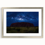 Abstract art print of Ayers Rock in muted orange and brown tones on a framed silver mat, ideal for dining room decor.
