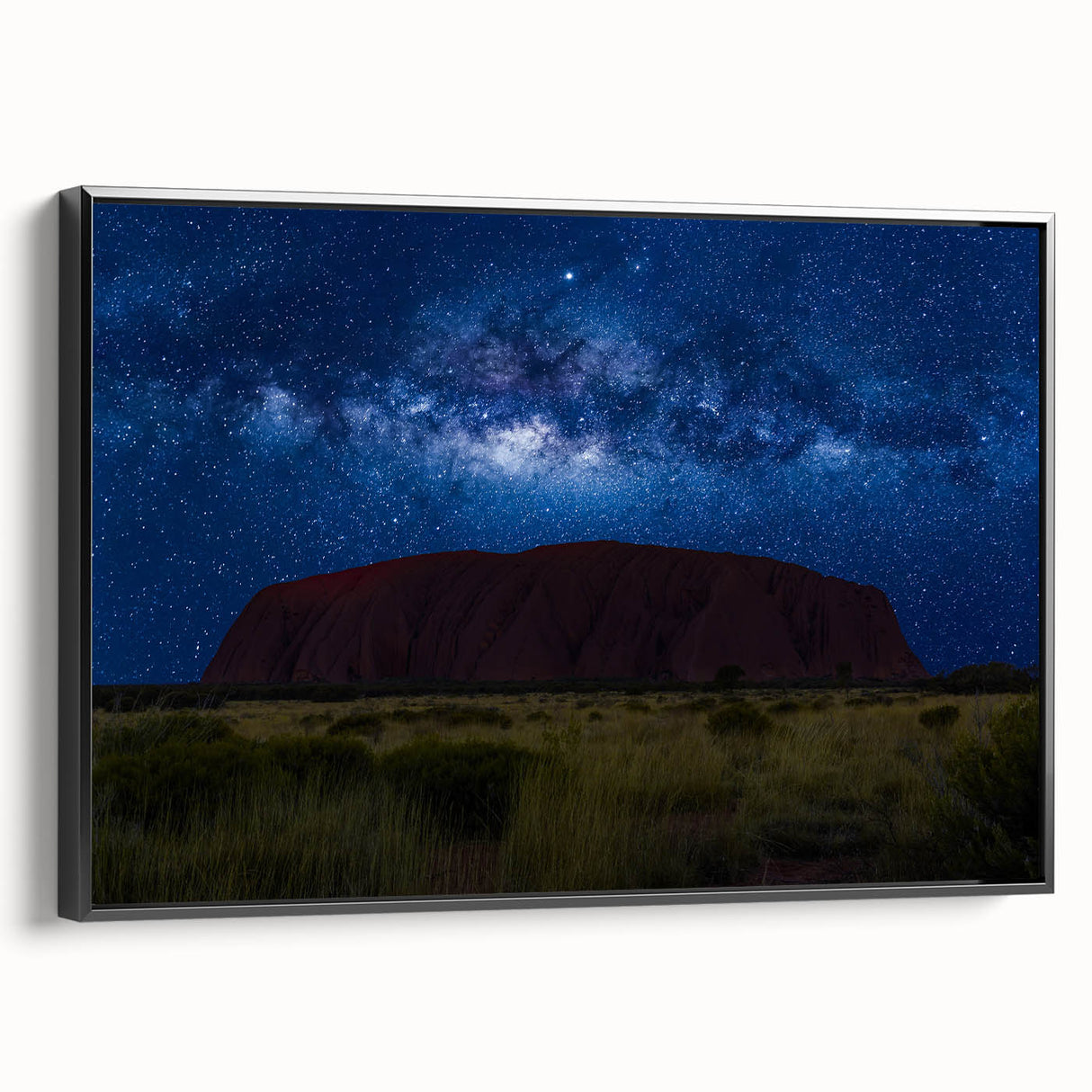 Black and white framed canvas of Ayers Rock landscape, suitable for bedroom decor.