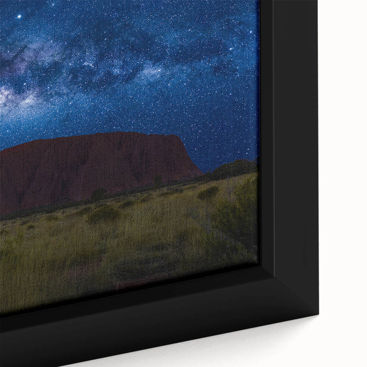 Close-up of extra large, framed canvas featuring Ayers Rock in black with textured, colorful art accents.