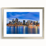 Extra large abstract art print of Sydney scenery in muted blue tones, framed in silver, ideal for living room decor.
