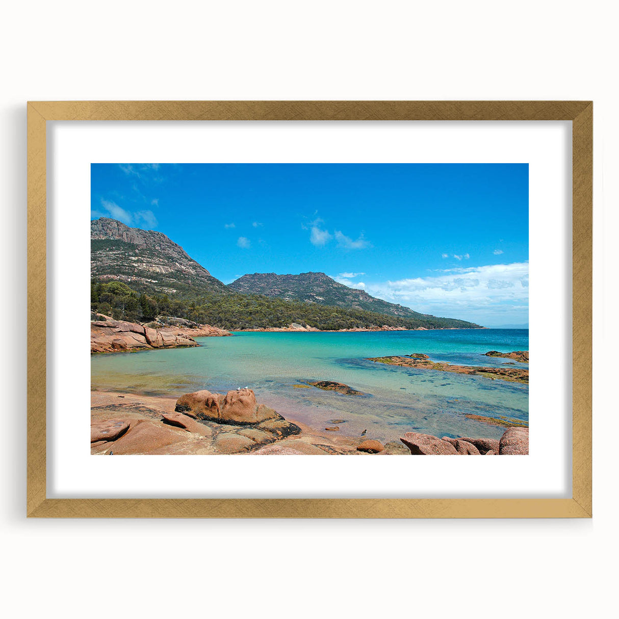 Textured abstract art print of a Tasmanian landscape in muted earth tones, framed in gold, ideal for bedroom decor.