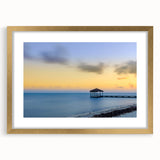 Textured abstract art print depicting Caribbean scenery in vibrant blue and green hues, framed in gold.