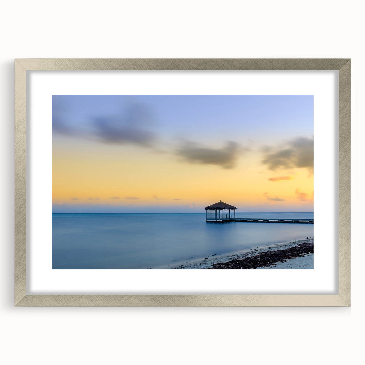 Abstract art print of a Caribbean scenery in muted blue and green tones, framed in silver, suitable for dining room decor.