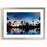 Extra large abstract art print of a Caribbean scene in vibrant blue and green tones, framed in silver.