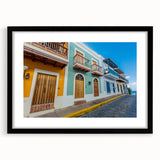Abstract art print of a vibrant Caribbean scenery in textured colors, framed in black, ideal for living room decor.