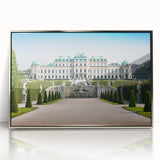 Large art print of a serene Austrian landscape in muted green and blue tones, framed in silver acrylic.