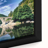 Framed canvas featuring a textured, colorful depiction of a European scenery in muted tones, ideal for living room decor.