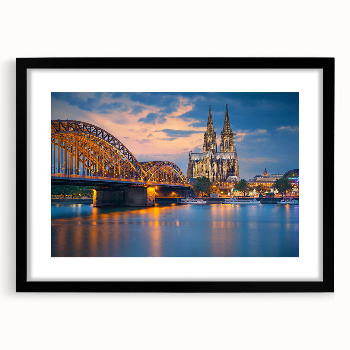 Extra large abstract art print of a colorful European scenery on textured canvas, framed in black.