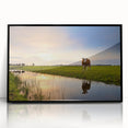 Large abstract wall art depicting a stylized European landscape in muted earth tones, framed in black acrylic.