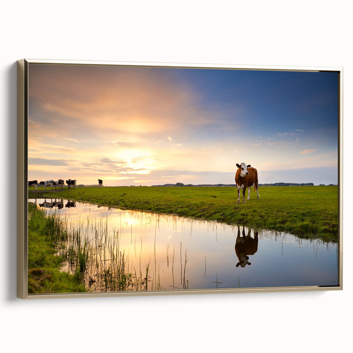 Framed canvas featuring a vintage-style landscape painting of a European scenery in muted gold and black tones.