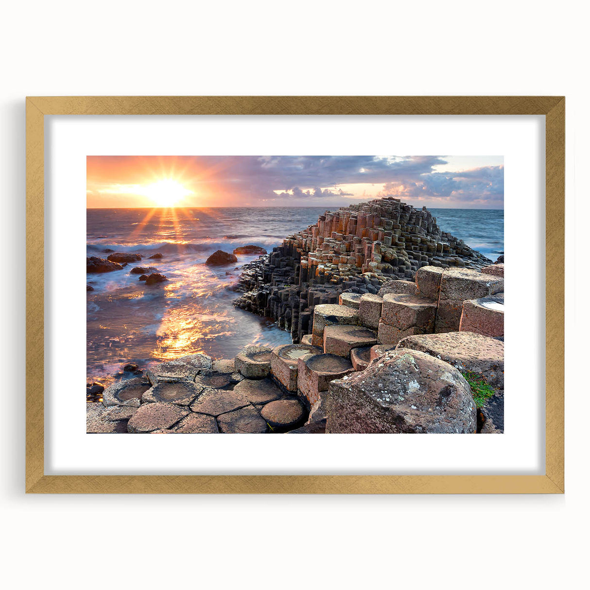 Abstract art print depicting the rugged Northern Ireland coastline in muted green and blue tones, framed in gold.