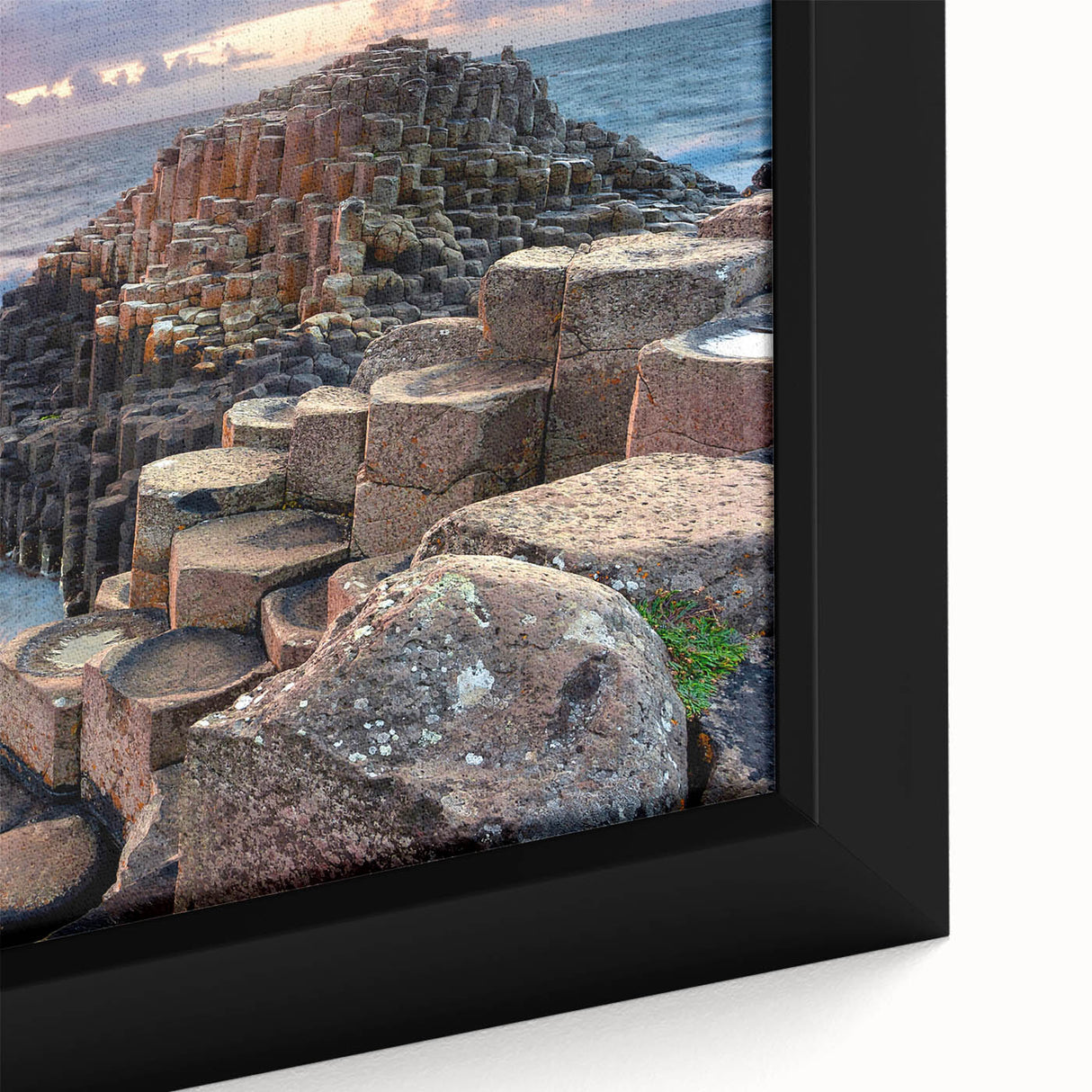 Close-up of a framed canvas depicting a textured, colorful coastal scene of Northern Ireland, ideal for living room decor.