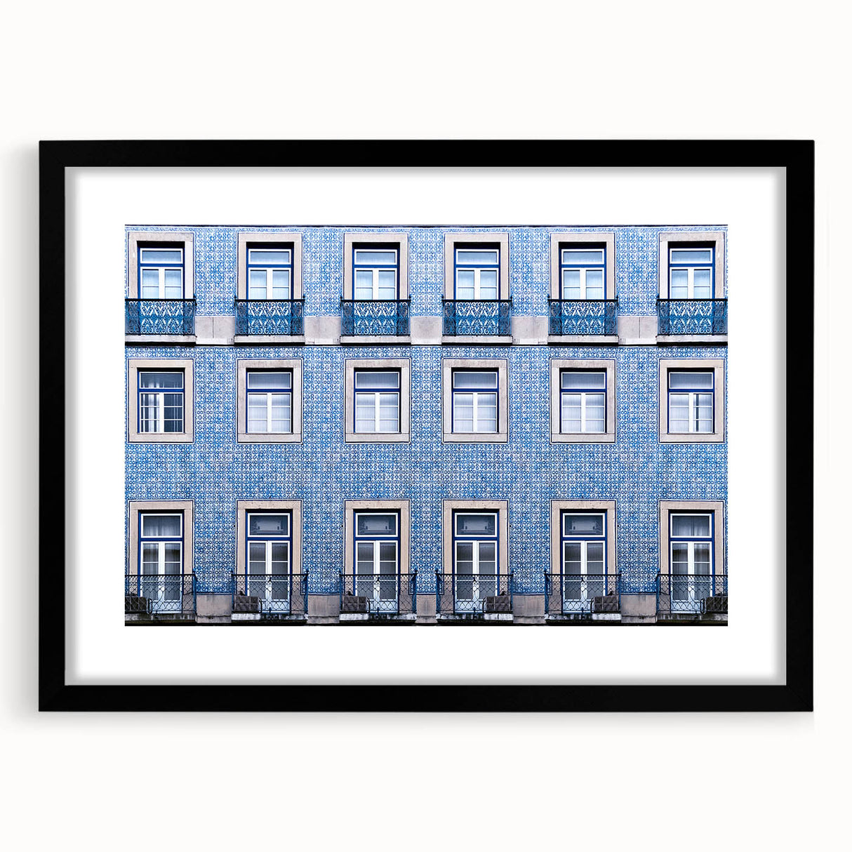 Colorful abstract art print of Lisbon scenery in vibrant hues on a large textured canvas, framed in black.