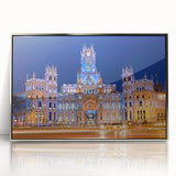 Mid-century modernist art depicting Madrid's skyline in muted earth tones on a silver-framed acrylic print.