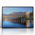Large abstract wall art depicting Geneva's skyline in muted blue and gray tones on a black-framed acrylic print.