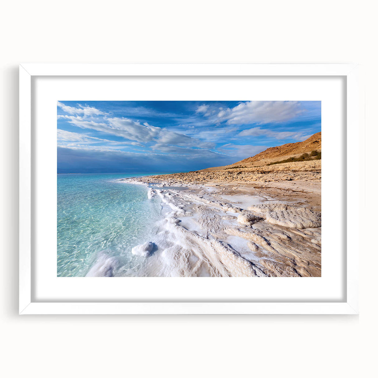 Abstract art print of the Dead Sea in muted blue and beige tones, framed with a white mat, suitable for dining room decor.
