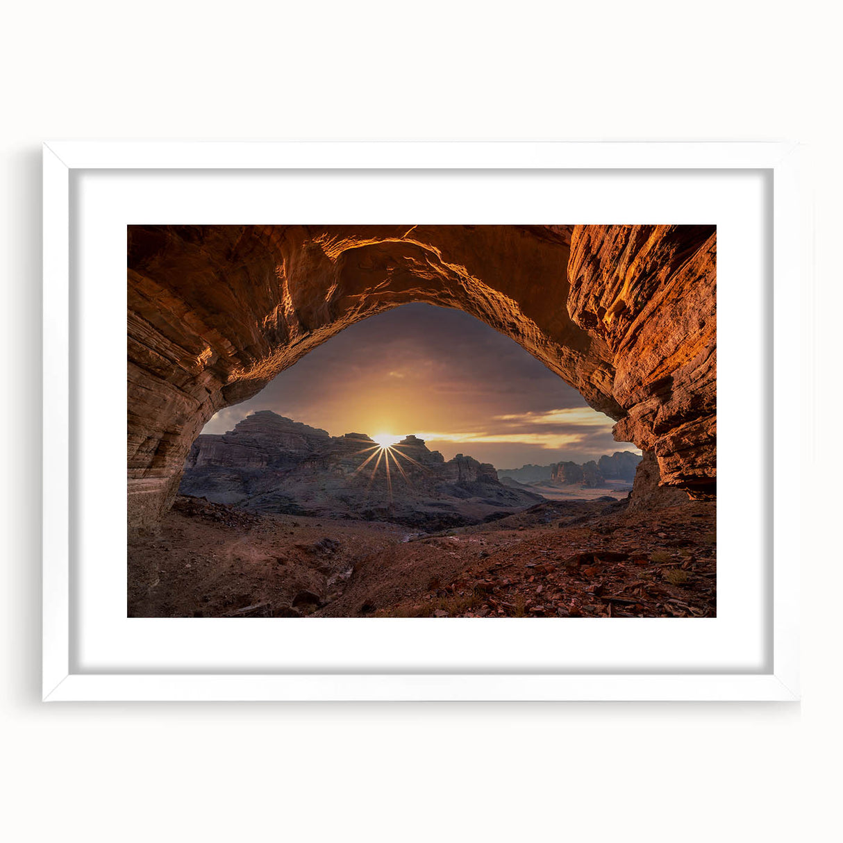 Abstract art print featuring muted earth tones of a Saudi Arabian landscape on a framed white mat.