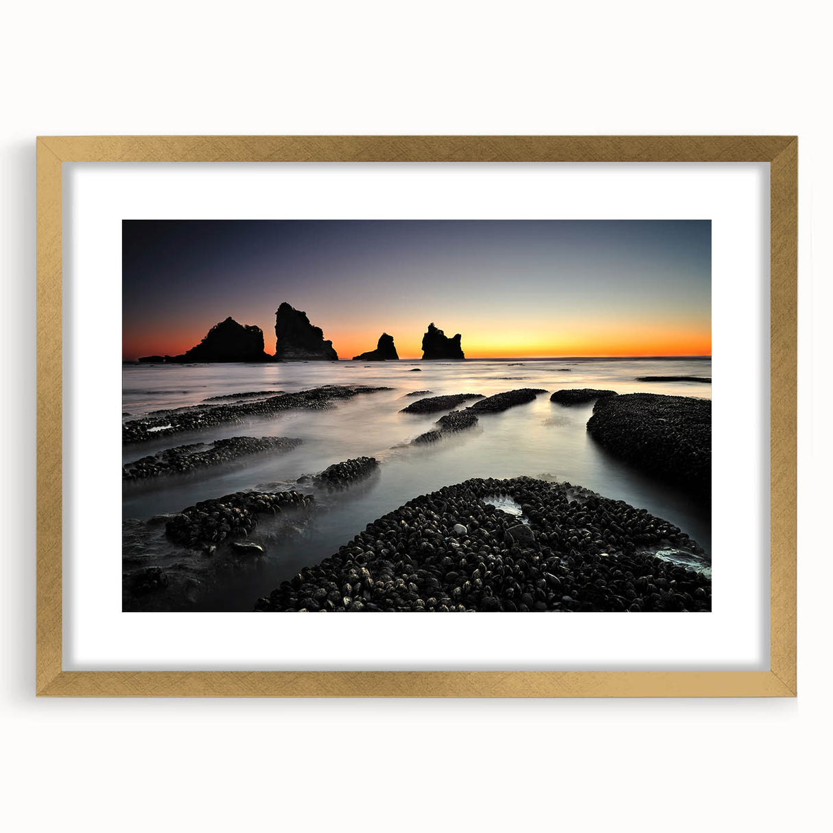 Extra large abstract art print of the New Zealand West Coast in gold frame, featuring textured gray and blue tones.