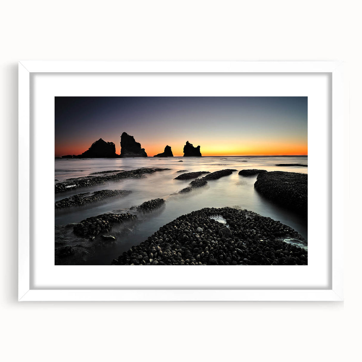 Abstract art print of New Zealand's west coast in muted blue and green tones on a white-framed canvas.